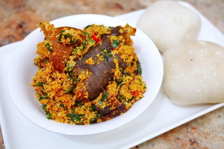 Delicious plate of Egusi soup served with a side of swallow, a popular Nigerian dish enjoyed by many.