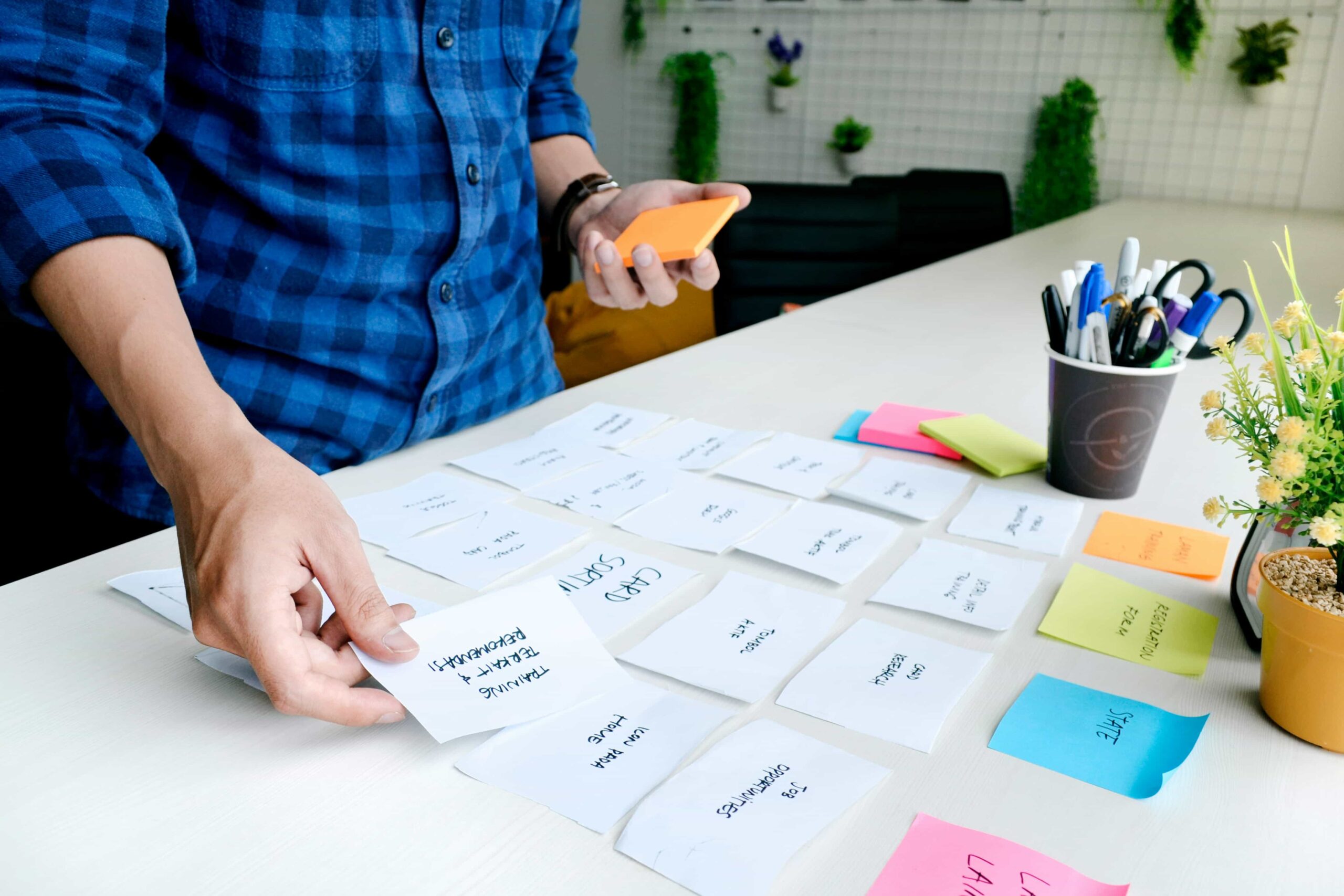 A man organising tabs on a desk while working on a digital project