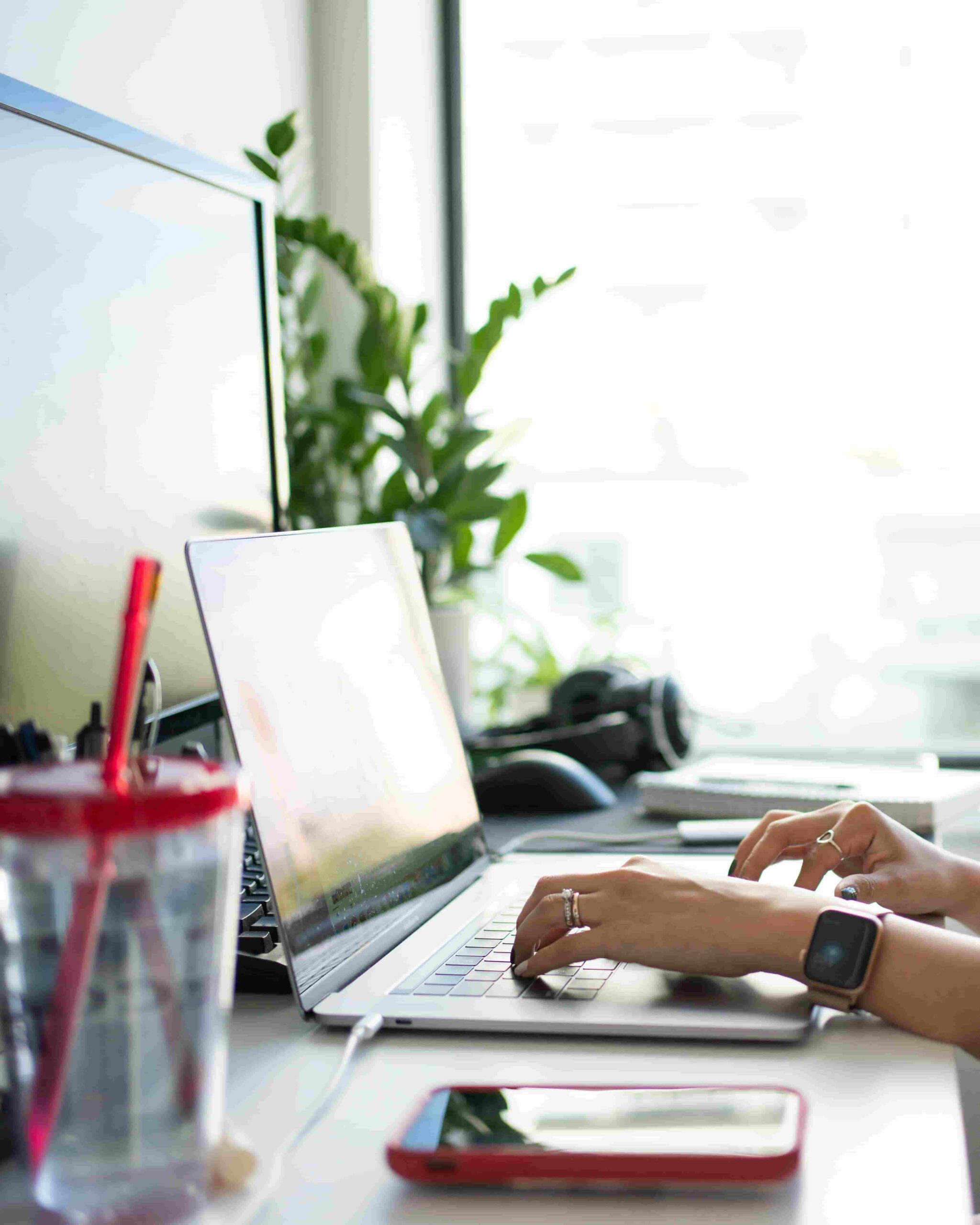 Woman working at her desk in a modern office environment, focused on her tasks